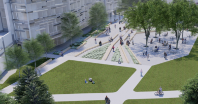 The open space in front of the new Northern Kentucky University Dorothy Westerman Hermann Science Center. A lawn with walking areas in between sit in front of the new center with trees all around providing shade.