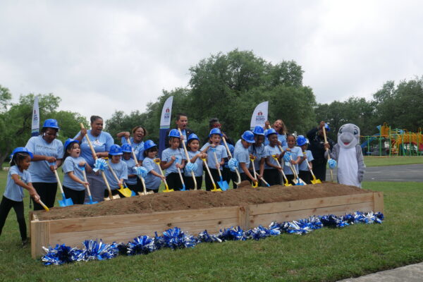 Austin ISD Invests in New Oak Springs Elementary as Part of $2 Billion Bond A group of students and teachers wearing blue Oak Springs Elementary shirts hold shovels at the groundbreaking of the project.