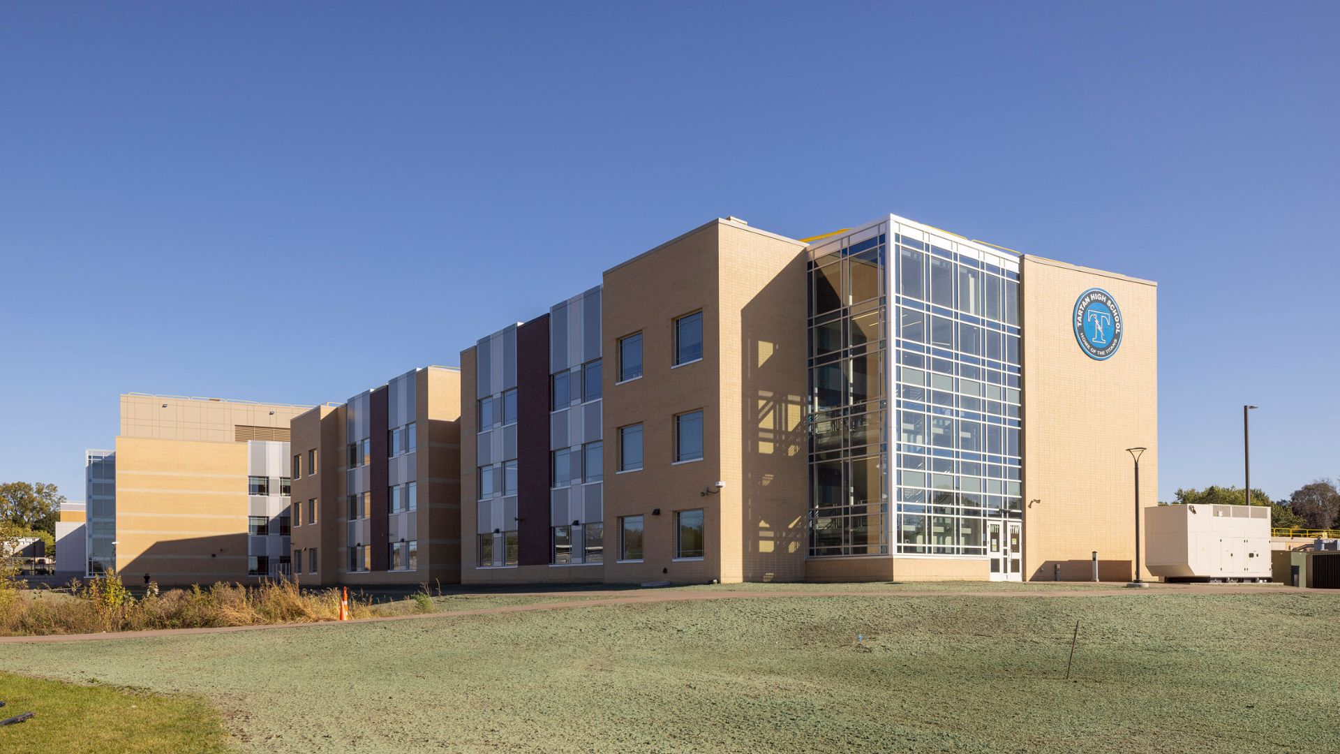 Rather than replacing the school, the district pursued an addition and renovation strategy that kept the campus operating on its existing site, reducing both cost and waste.