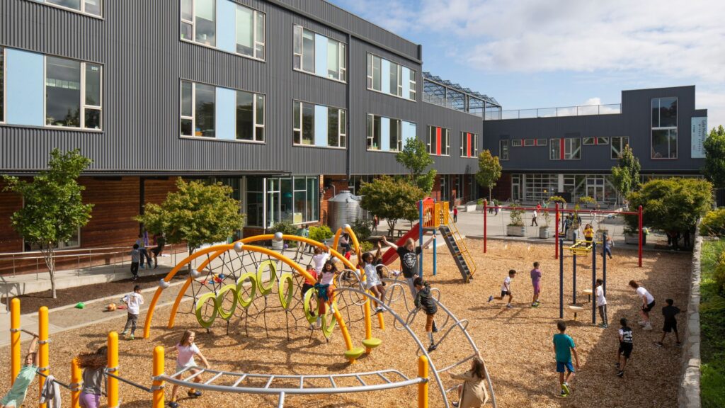 Outdoor space within the “L” functions as both a daily play area and an exterior performance venue. 