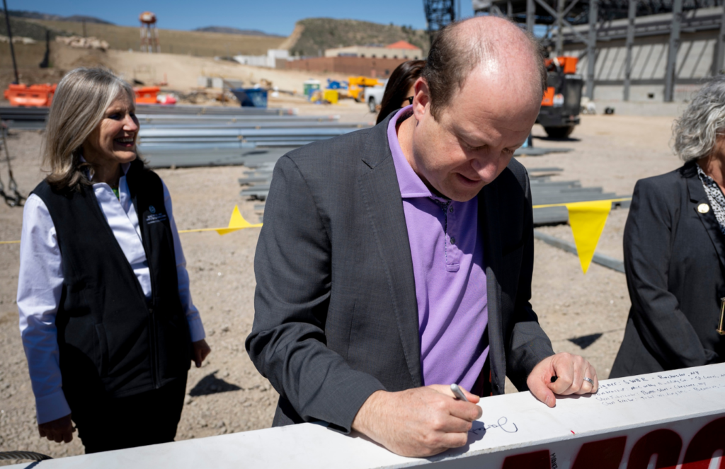 Gov. Jared Polis attended the topping out ceremony and signed the ceremonial beam.