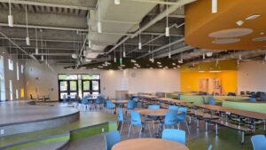 Larger shared spaces include a first-floor cafetorium described as the school’s “Social Heart,” a lower-level gymnasium and gathering stairs that can accommodate informal seating and interaction among students, staff and families.